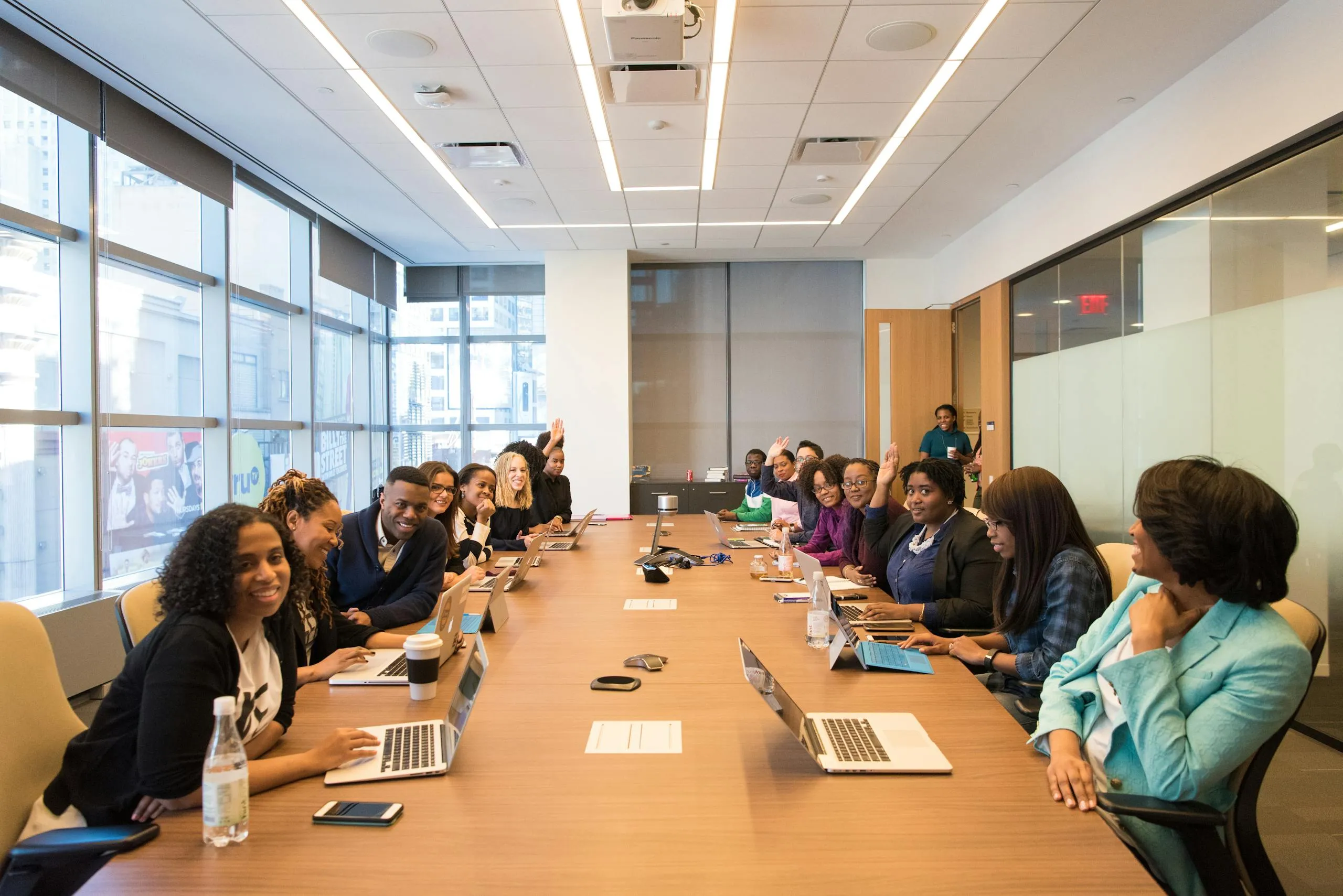 Professionals in a meeting around a conference table.